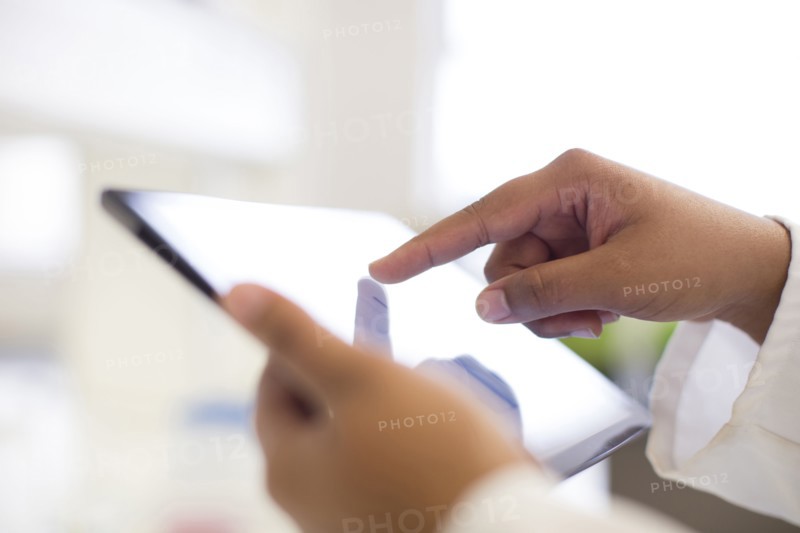 Mixed race scientist using digital tablet in laboratory