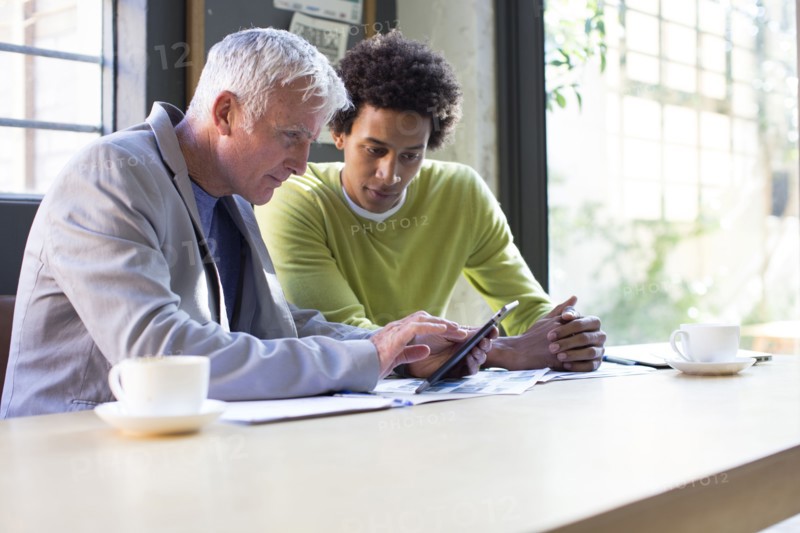Business people using digital tablet in office meeting