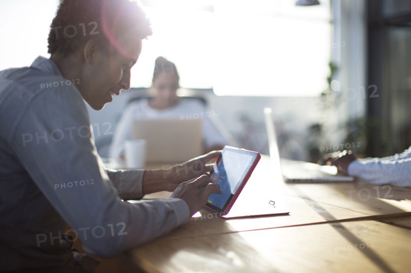 Mixed race business people using technology in office
