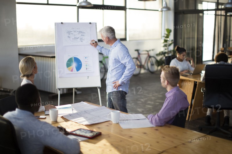Businessman giving presentation in office meeting