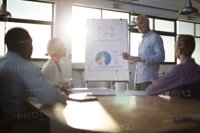 Businessman giving presentation in office meeting
