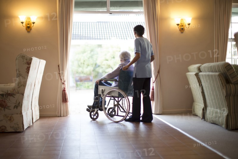 Nurse pushing patient in wheelchair