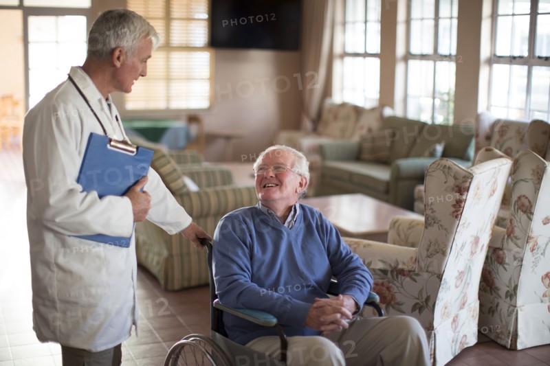 Doctor talking to patient in wheelchair