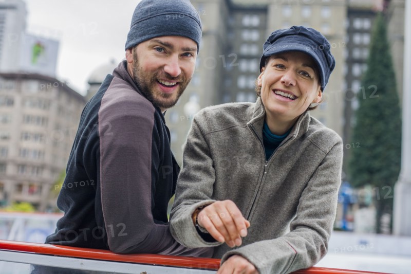 Portrait of smiling Caucasian couple at ice skating rink