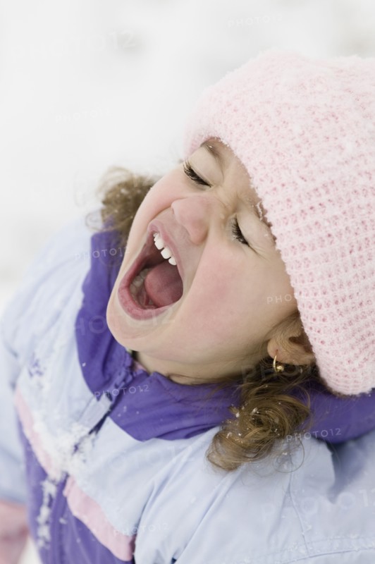 Young girl yelling in snowsuit outdoors