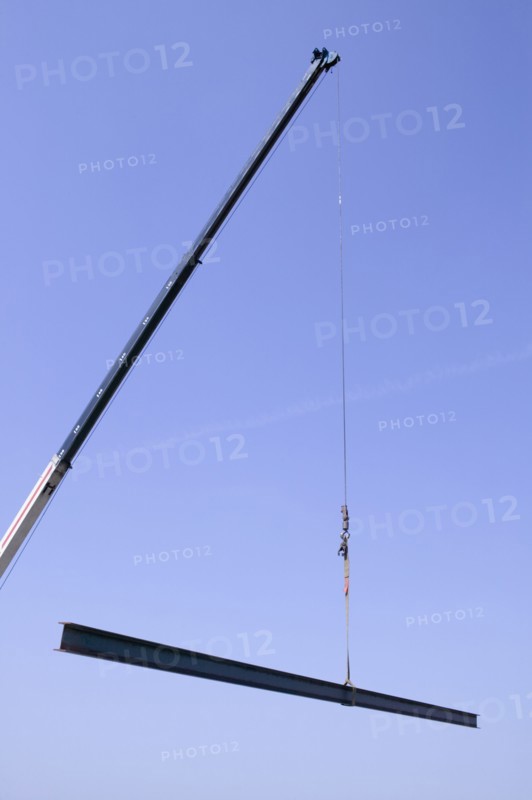 Crane holding steel beam