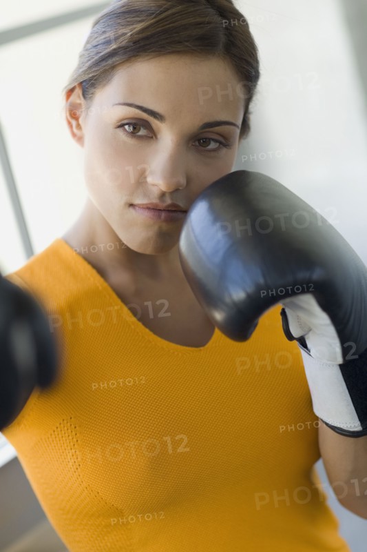 Mixed race woman boxing