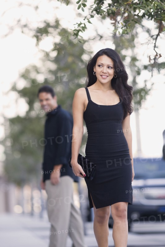Hispanic man watch sexy woman walk down the street