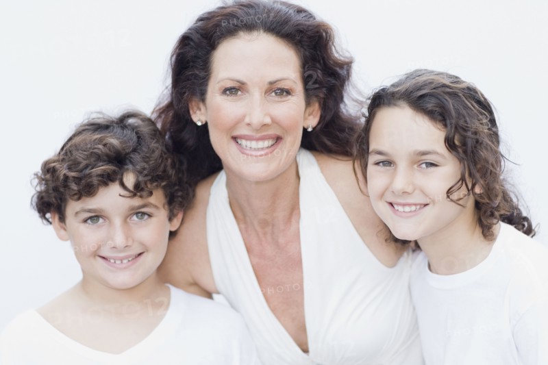 Mother posing with son and daughter for portrait