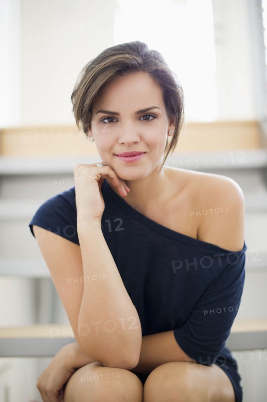 Glamorous Hispanic woman with hand on chin
