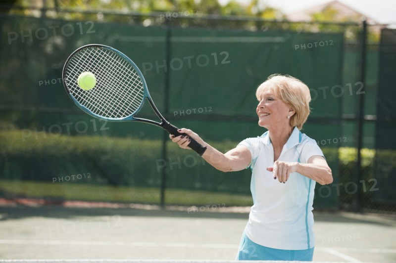 Caucasian woman playing tennis
