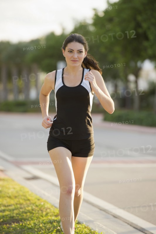 Hispanic woman running outdoors