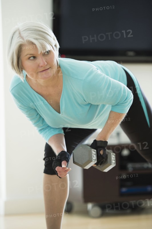 Caucasian woman exercising with hand weights