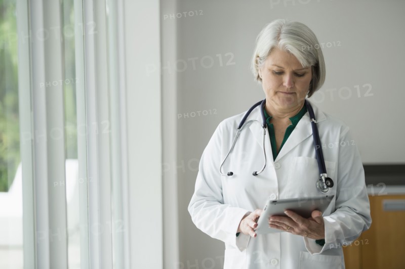 Caucasian doctor using digital tablet