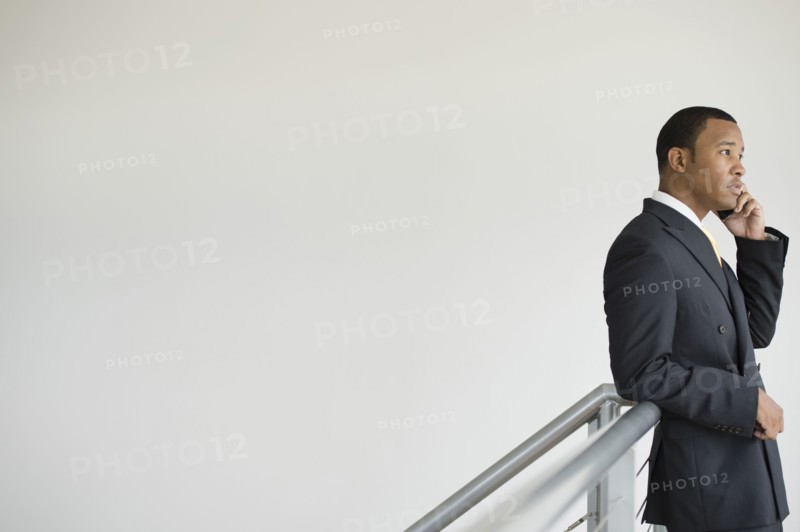 Mixed race businessman talking on cell phone