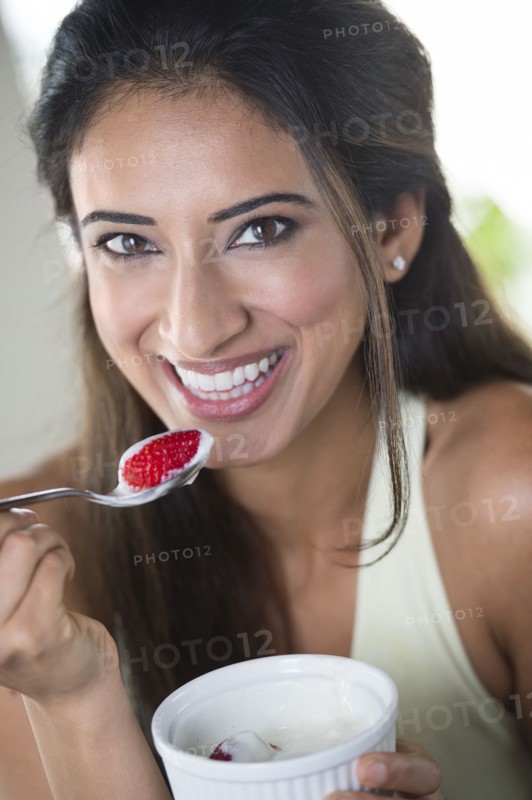 Indian woman eating fruit