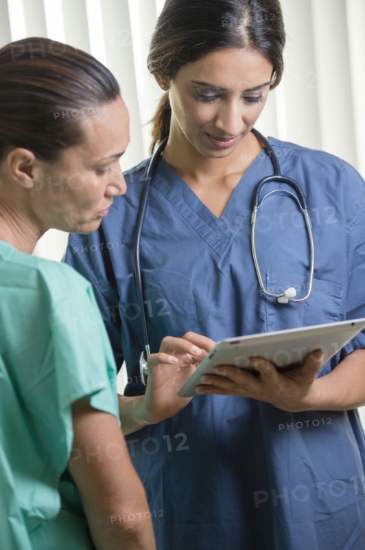 Nurses using tablet computer
