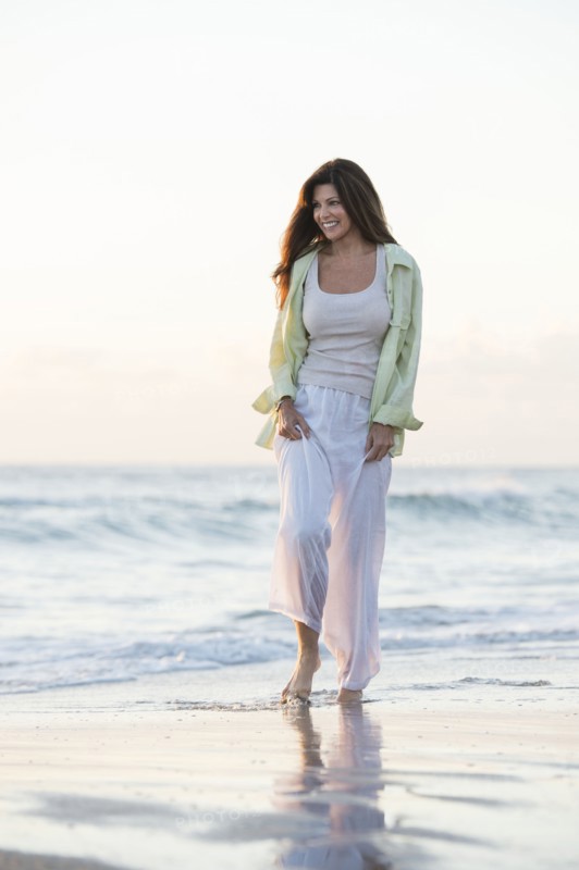 Caucasian woman walking on beach