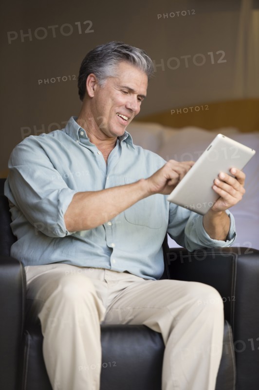 Caucasian man using tablet computer