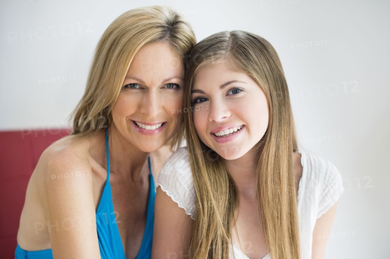 Caucasian mother and daughter smiling together
