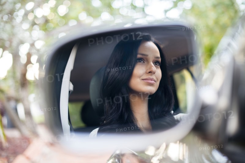 Hispanic woman driving car