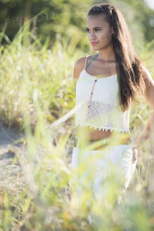 Mixed race woman walking in tall grass