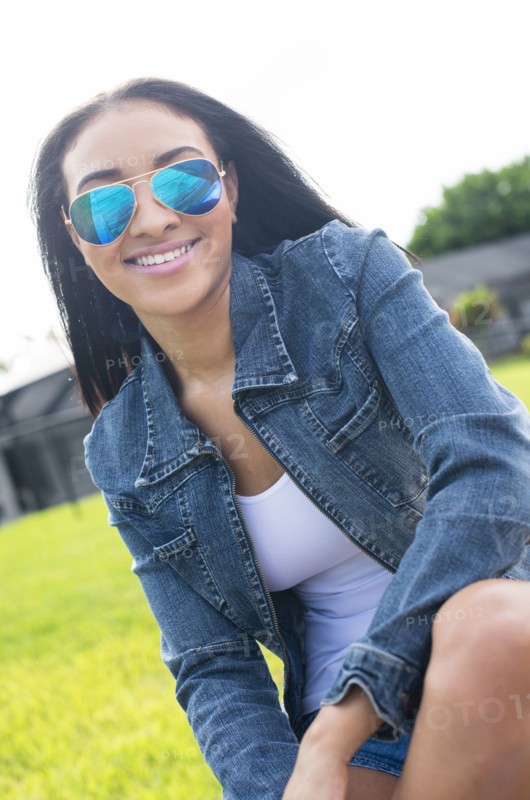 Close up of Black woman in sunglasses smiling