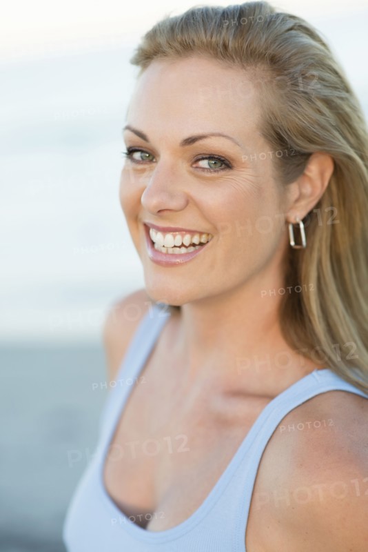Caucasian woman smiling on beach