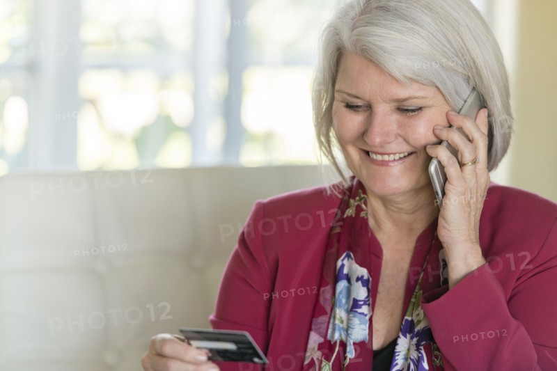 Caucasian older woman shopping with cell phone
