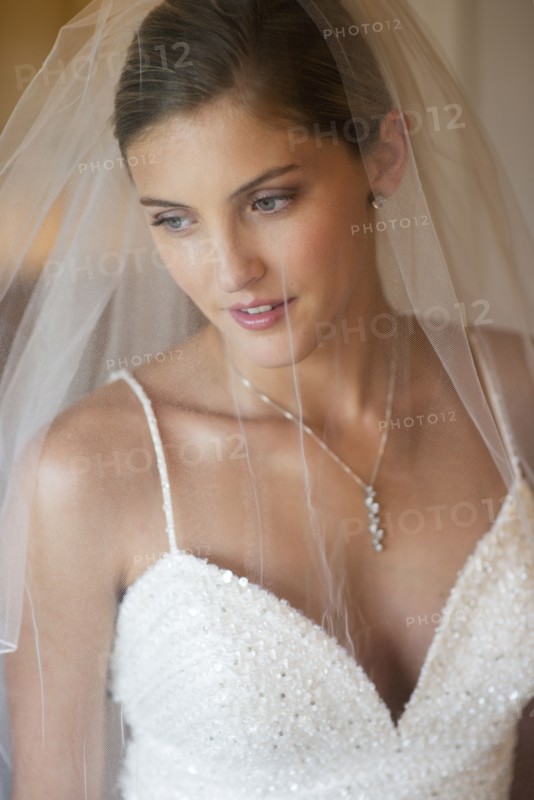 Caucasian bride wearing wedding gown and veil