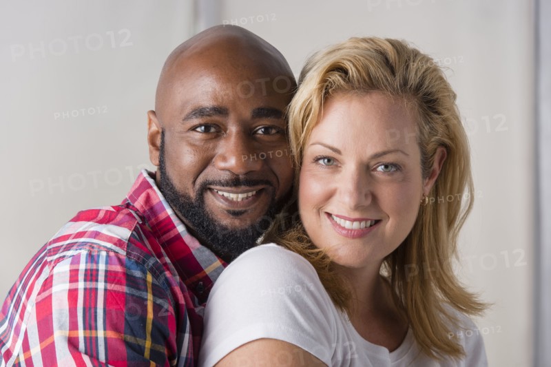Close up of smiling couple hugging