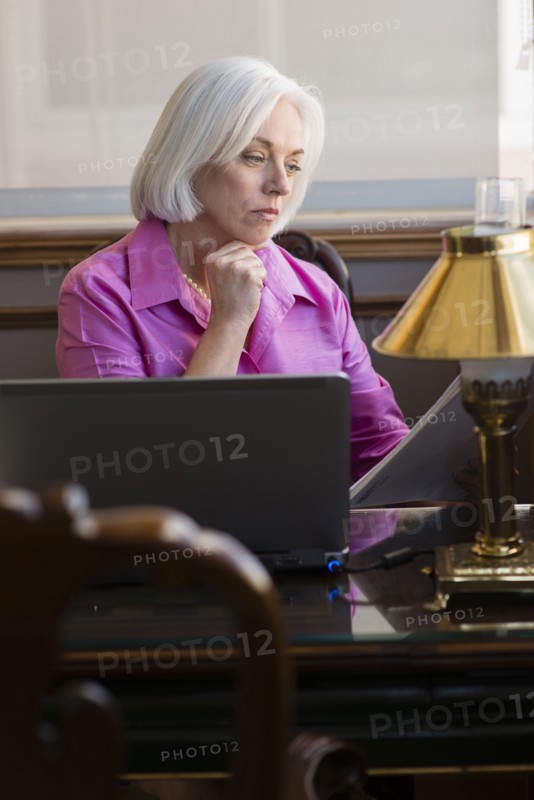 Caucasian businesswoman working at office desk
