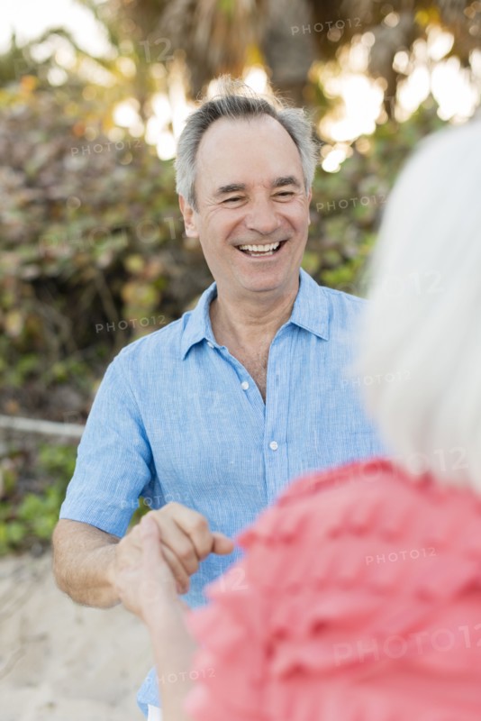 Close up of older Caucasian couple talking on beach