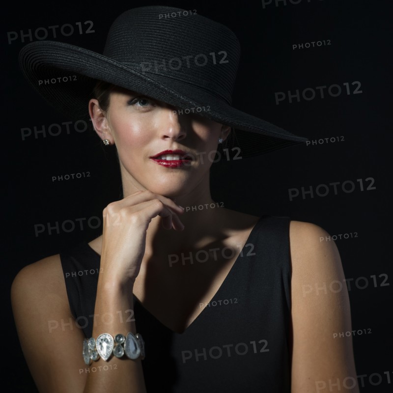 Stylish Caucasian woman wearing black hat and dress