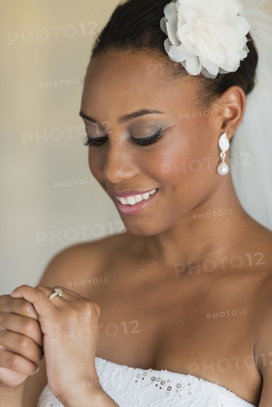 Mixed race bride wearing wedding gown and veil