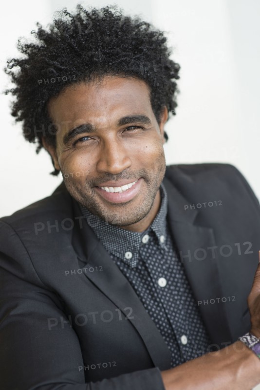 Close up of smiling Hispanic businessman