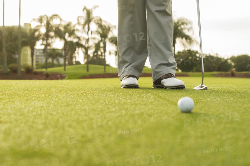 Caucasian man standing on golf course green