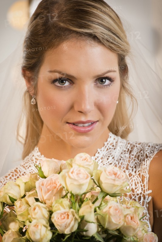 Close up of bride holding bouquet of flowers