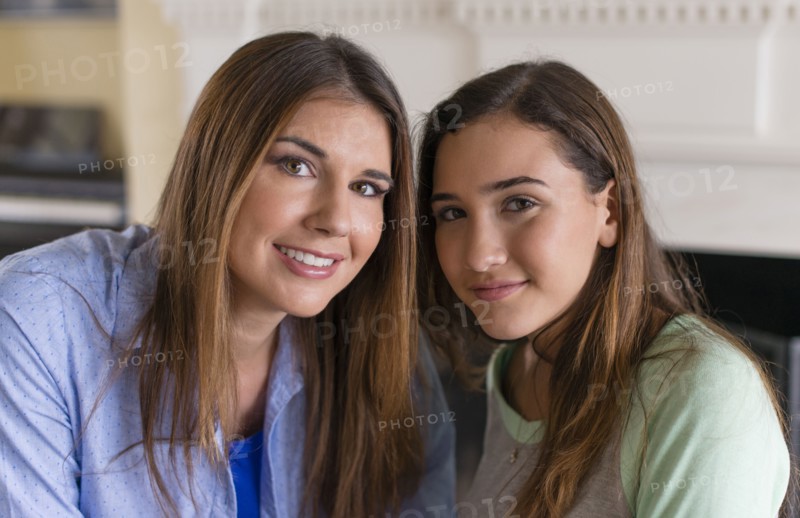 Mother and daughter smiling indoors