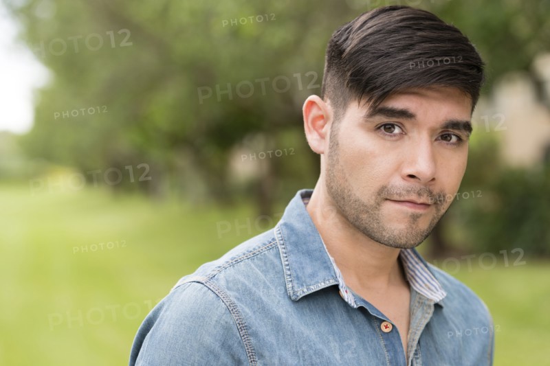 Serious Hispanic man outdoors