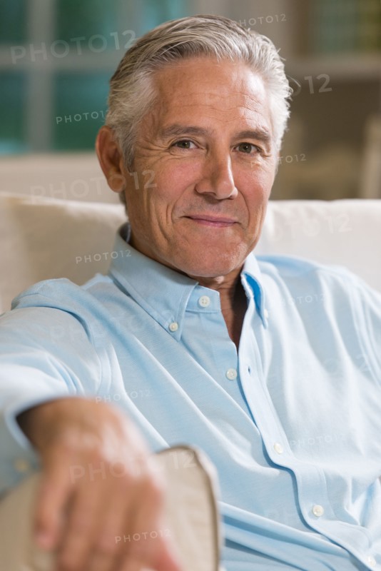 Caucasian businessman smiling on sofa