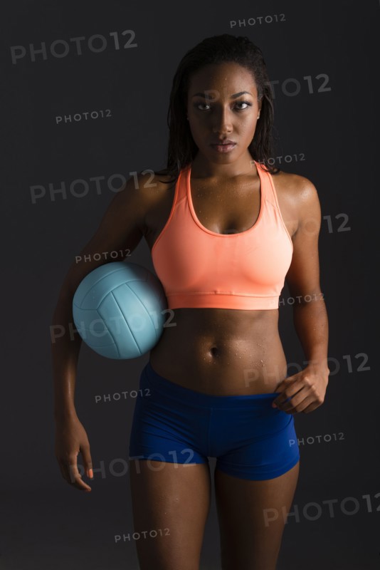 African American woman holding volleyball
