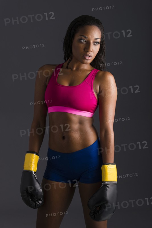 African American woman wearing boxing gloves