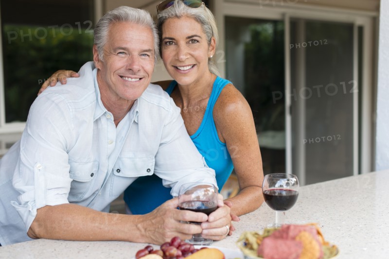 Caucasian couple drinking wine at table