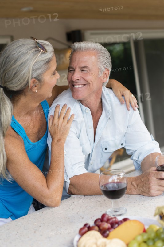 Caucasian couple drinking wine at table