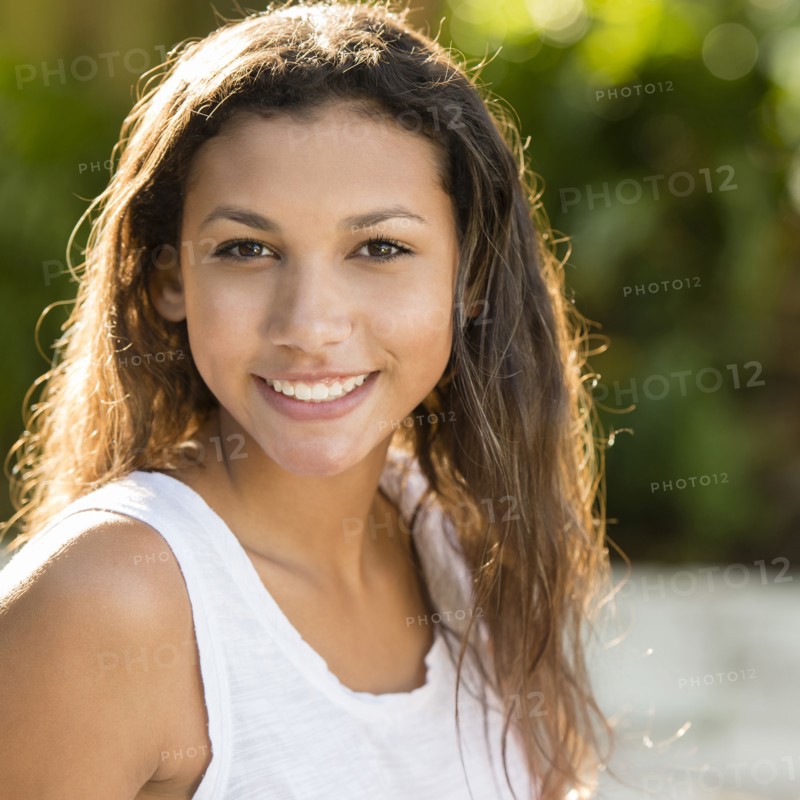 Mixed race teenage girl smiling outdoors