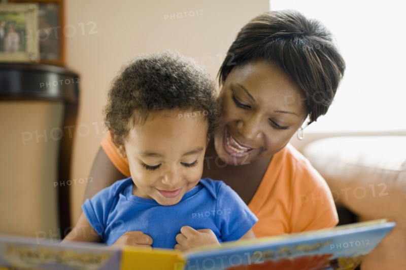 African mother reading to young son