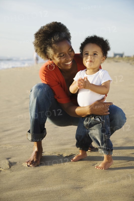 African mother on beach with son