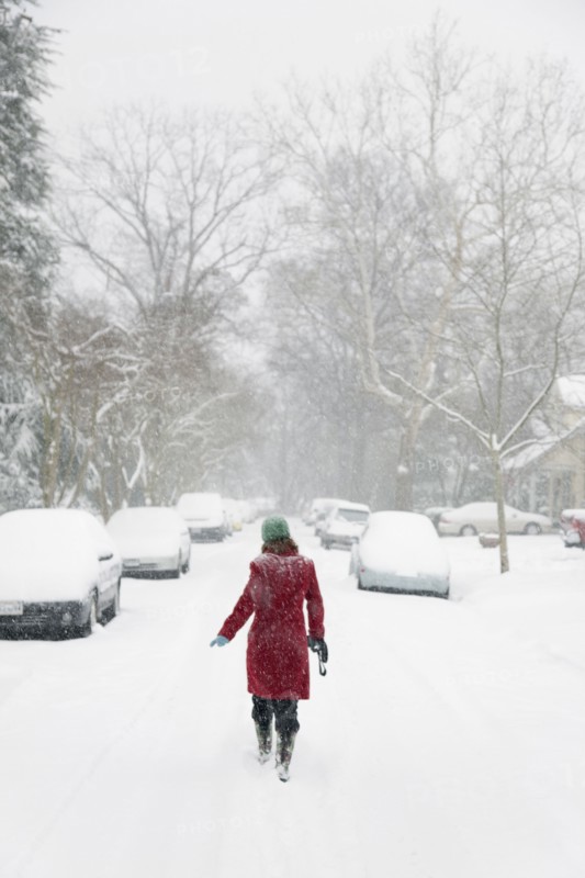 Caucasian woman walking in snow storm