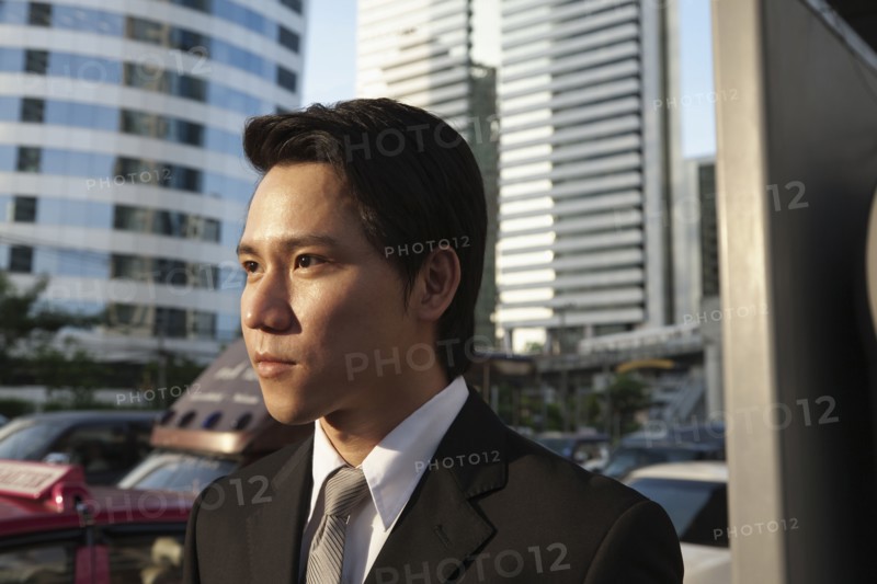 Serious Asian businessman outdoors